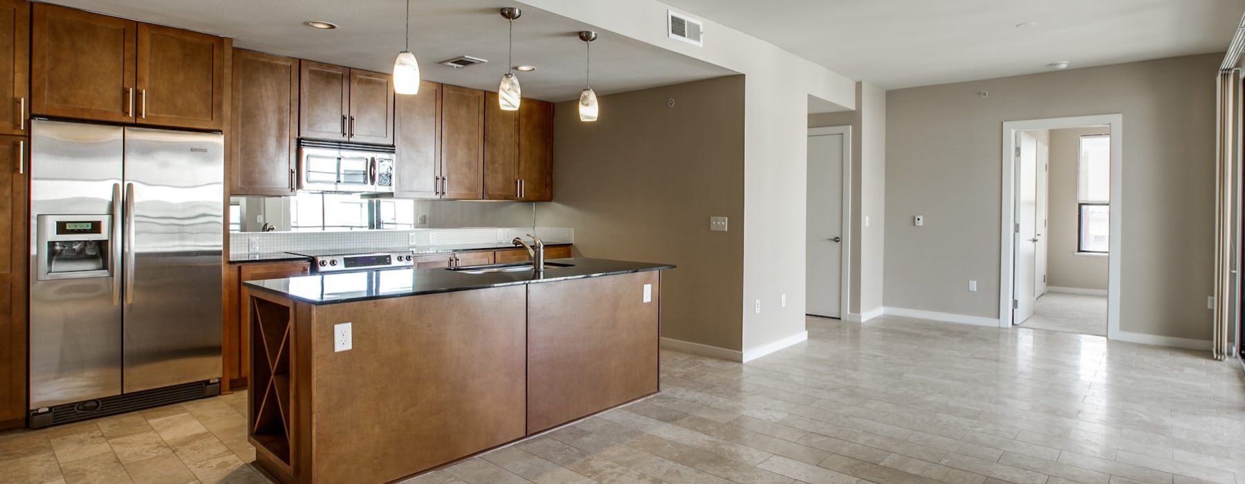 a large kitchen with stainless steel appliances and an island