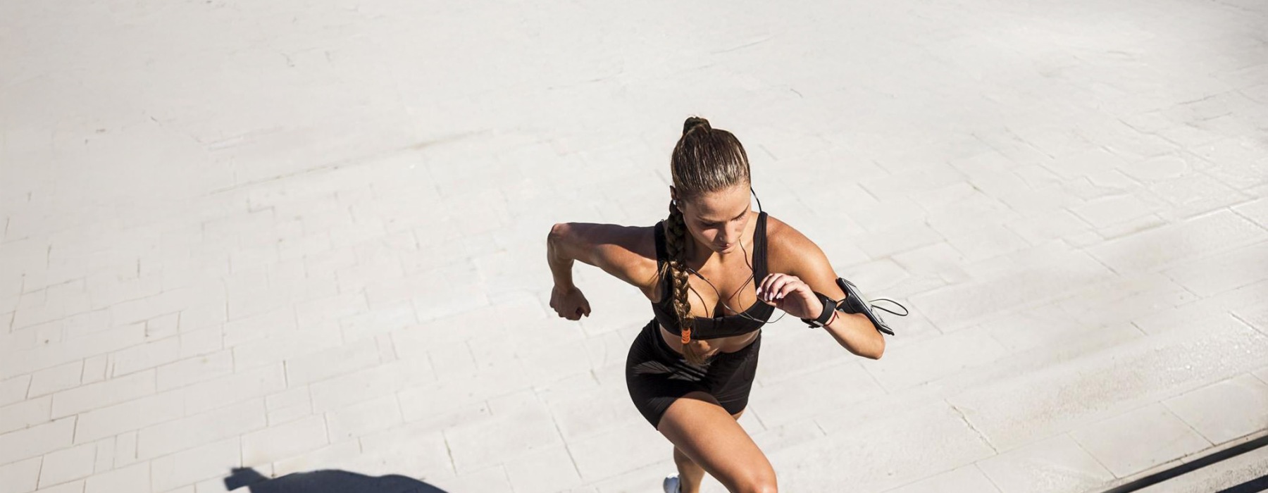 woman exercises running outside up stairs